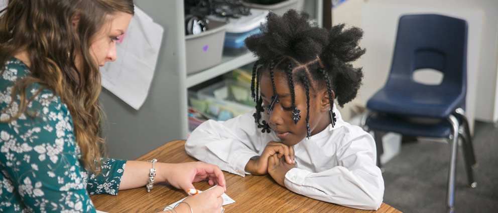 Teacher helping student