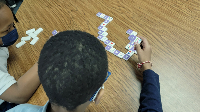 Students playing dominos.