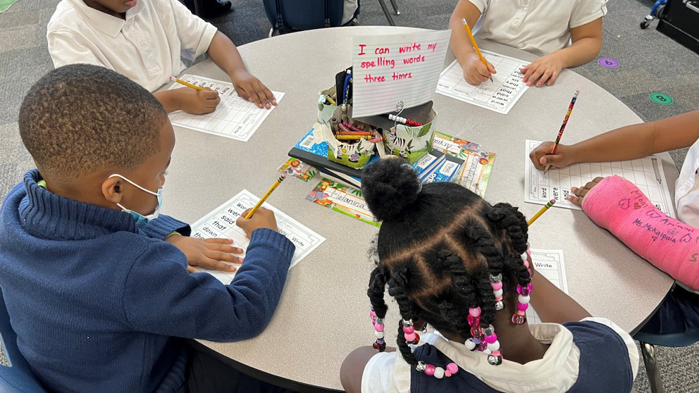 Students writing at table