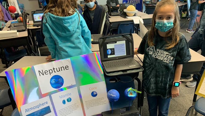 A Peak scholar shows off their model of Neptune