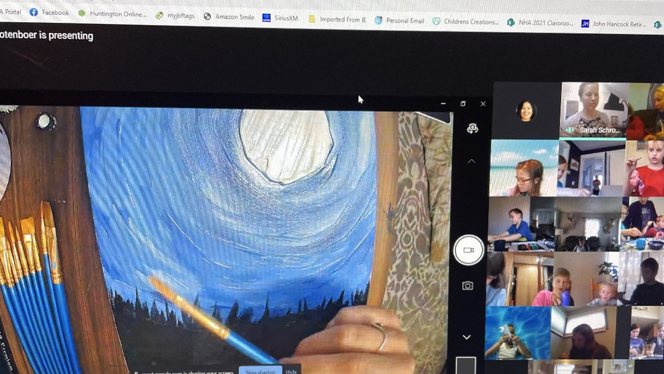 A student painting a moonlit night.