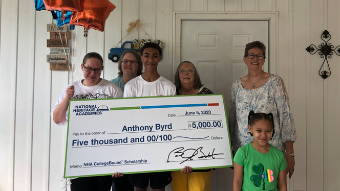 Anthony Byrd holding scholarship with his family