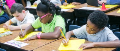 Students completing work in classroom