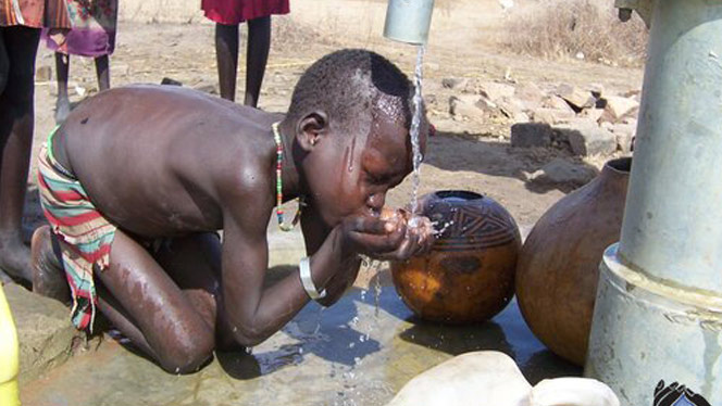 South Sudanese child drinking water.