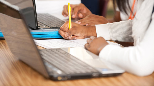 Student raising his hand in class