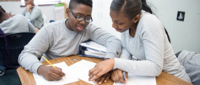 Brooklyn Excelsior Charter School, K-8 School in Brooklyn, NY: two students working on classwork.