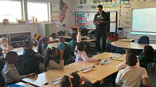 K-8 School in Ypsilanti: EMU football players visited East Arbor students.