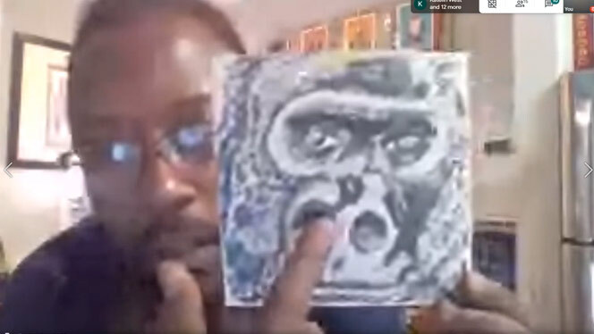 Man holding up artwork of a guerilla.