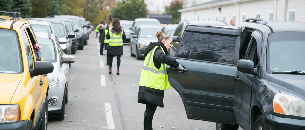 Helping student into car