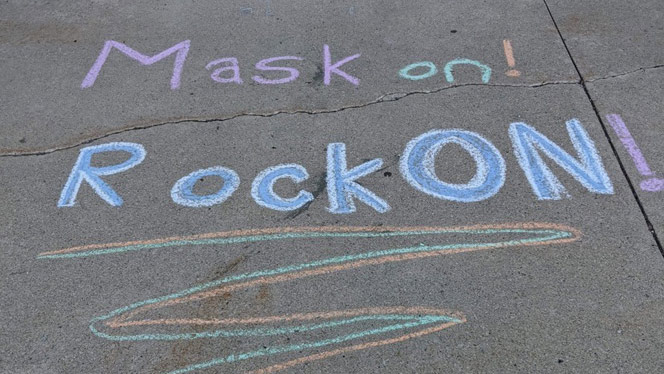 Sidewalk chalk reminding onlookers to wear their masks.