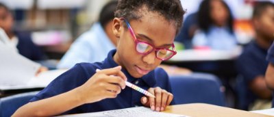 K-8 School in E. Cleveland: Student writing in notebook.