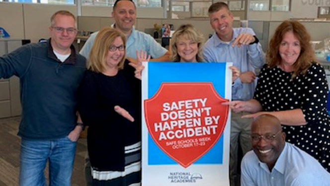 People around a sign that says Safety Does Not Happen By Accident.