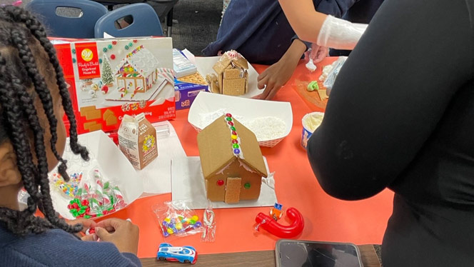 Families make gingerbread houses.