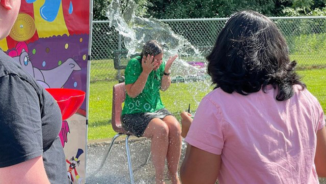 Teacher gets wet in the dunk booth