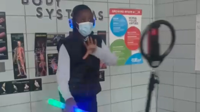 A student holding a glow stick.