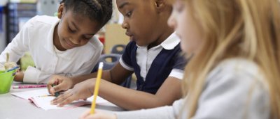 Three students completing work