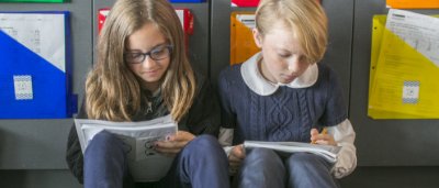 Two students completing work