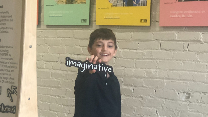 Student holding word "imaginative"