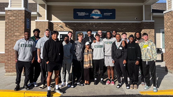 K-8 School in Ypsilanti: EMU football players visited East Arbor students.
