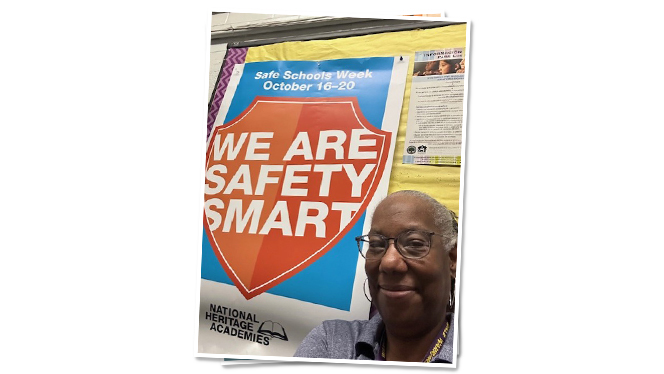 Kemp with "We are Safety Smart" poster.
