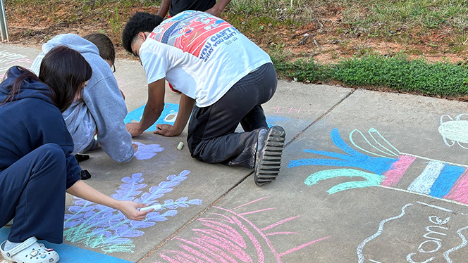 K-12 School in High Point: Phoenix Academy seniors decorate elementary and middle school buildings to help ease young scholars first day of school jitters.
