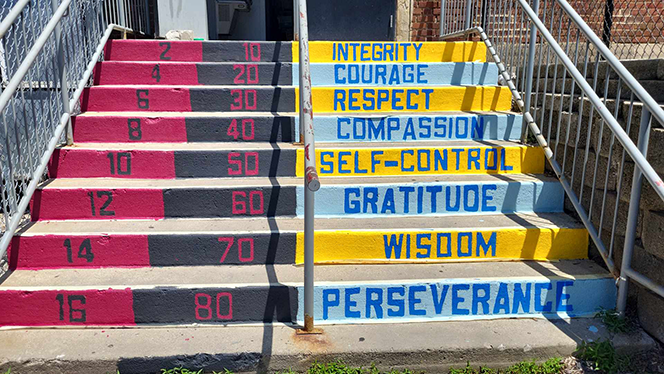 K-8 School in East Cleveland: Apex Academy Art Club and Art Teacher painted Moral Focus virtues on the school's back steps as part of a summer break project.