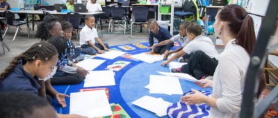 Teacher helps students complete work