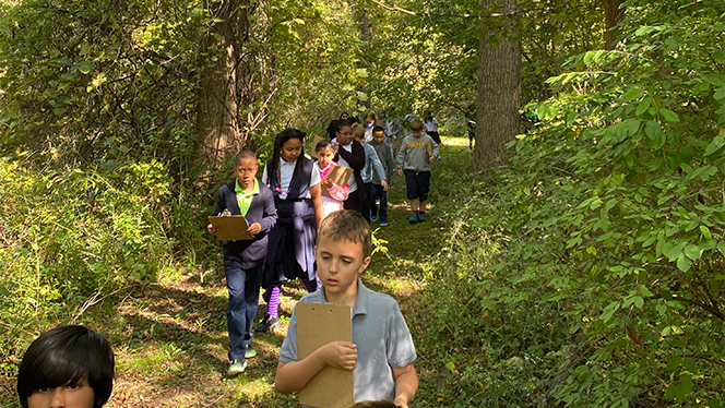Students walking on trail.
