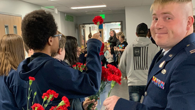 Veterans receiving carnations.