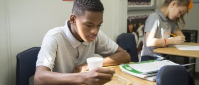 Two students completing work in classroom